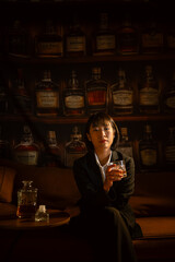 Closeup business woman holding a glass of whiskey