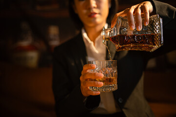 Closeup business woman holding a glass of whiskey