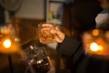 Closeup business woman holding a glass of whiskey