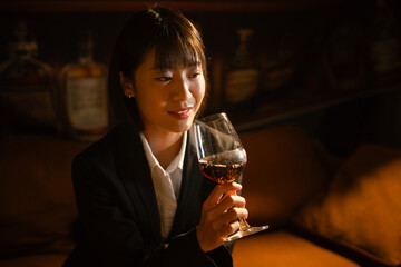  Closeup business woman holding a glass of wine