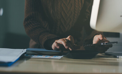 Close-up of businessman's hands making notes, mobiles, chart, desk, office