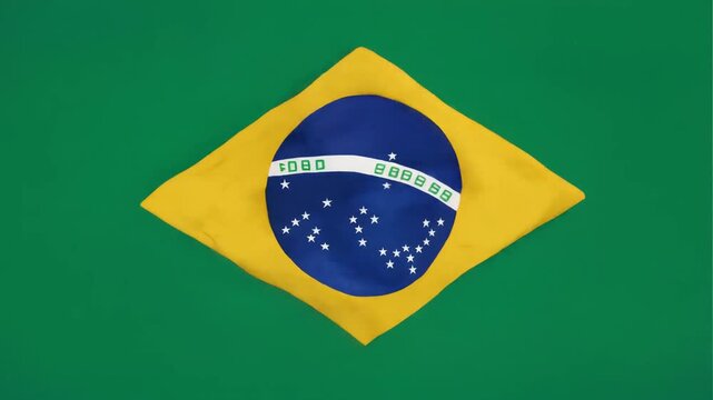 High resolution footage of the Brazilian flag waving slowly with bright green yellow and blue colors isolated on a seamless deep green background with vivid detail smooth motion and minimal clean styl