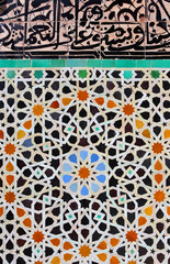 Fez, Morocco. Detail of colorful old, Islamic design, glazed ceramic wall tiles and Arabic calligraphy 
