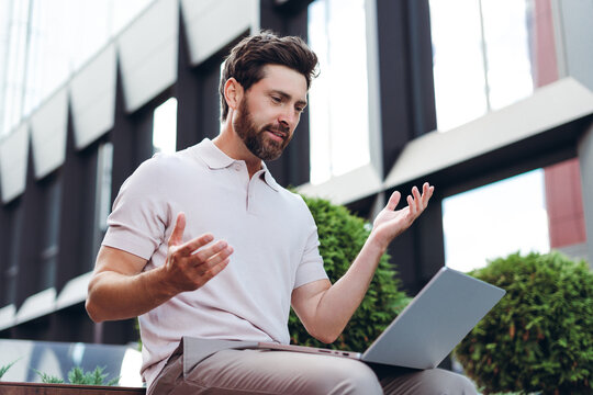 Man having video call using laptop outdoors