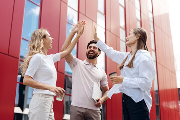 Business team high fiving celebrating collaboration and success
