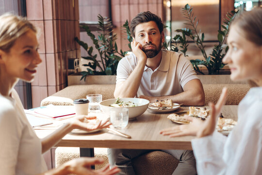 Man feeling bored during a social lunch at restaurant