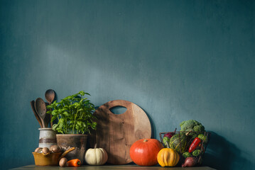 Kitchen table with vegetables against the background of an old textured wall