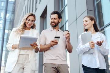 Business team discussing project outdoors on coffee break
