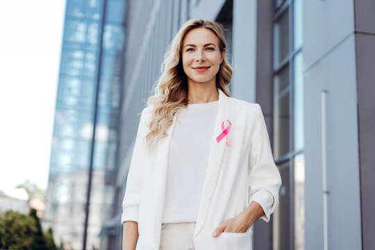 Woman wearing pink ribbon supporting breast cancer awareness - Powered by Adobe