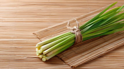 Fresh aromatic lemongrass bundle, raw organic herb tied with string on bamboo mat. natural ingredient with refreshing scent, perfect for healthy cooking and wellness