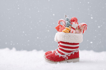 festive santa boot filled with gifts and holiday treats sits prominently against snowy landscape