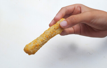 hand holding golden fried stick on white background