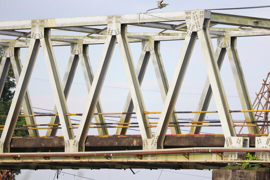 Old steel truss bridge structure with metal frame and visible rusty details outdoors - Powered by Adobe
