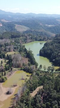 Aerial drone video of scenic lake in the Capixaba mountains, Esp&iacute;rito Santo, Brazil &ndash; lush tropical landscape and natural scenery