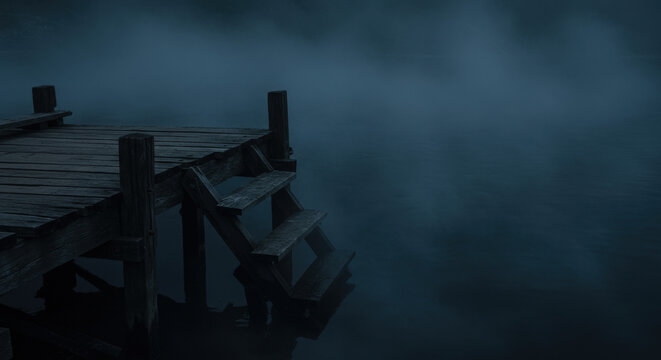 Serene lakeside boardwalk surrounded by ethereal blue haze