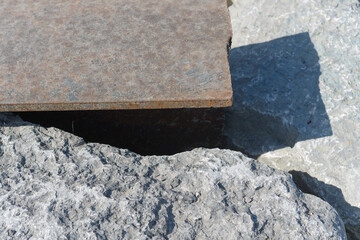metal beam surface and stones outdoors
