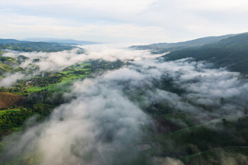 Aerial view of rice terraces and village in Loei province, Thailand.