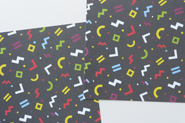 black crafting squares with geometric shapes (square, circle, symbols) on blank paper