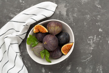 Fresh tasty fig fruits on concrete background, top view