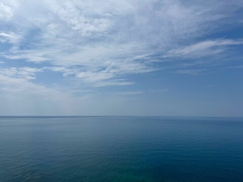 Open sea blue water and sky clouds.