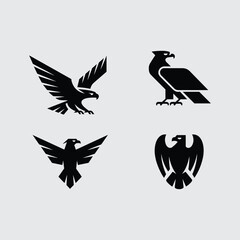 Four black silhouette logos of eagles in different poses Keywords: eagle, bird, silhouette, logo