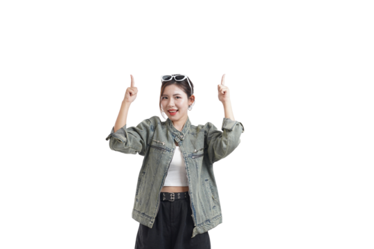 Pointing Upwards: A stylish woman in a denim jacket playfully points upwards with both index fingers, wearing sunglasses. Capturing a moment of joy, curiosity and direction.