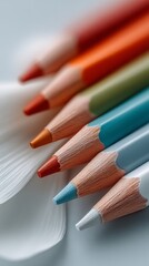 Naklejka premium Sharpened colored pencils, in vibrant red, orange, green, and blue hues, for art, creativity, and education, with copy space.