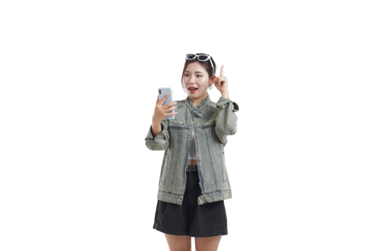 Smartphone Interaction: A young woman engaged in a lively smartphone conversation, possibly video call, expressing a moment of inspiration with a raised finger. capturing the vibrant interaction.