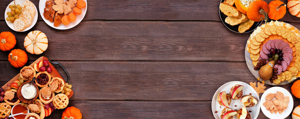 Thanksgiving appetizers, sweets and grazing boards. Top down view double border on a dark wood banner background. Pumpkin and apple snacks, pies, turkey cheese platter, desserts.