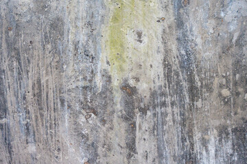 Weathered Concrete Wall. Old weathered concrete wall with visible scratches, stains, and moss. Industrial and rustic background.