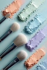 Makeup brushes and pastel eyeshadow powder arranged diagonally on a light blue background surface