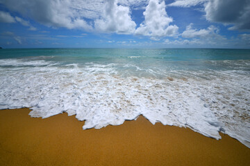 Seascape Serenity: A tranquil vista of a golden shore meeting turquoise ocean under a vibrant sky...