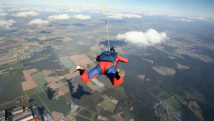 Skydiver in Freefall Above Green Landscape