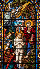 Stained glass (1934) of Baptism of Jesus by John the Baptist in the Jordan river.