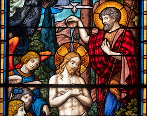 Stained glass (1934) of Baptism of Jesus by John the Baptist in the Jordan river.