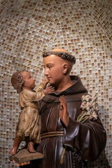 Statue (19th century) of Saint Anthony of Padua holding baby Jesus Christ in his arms. Saint of the Roman Catholic Church.