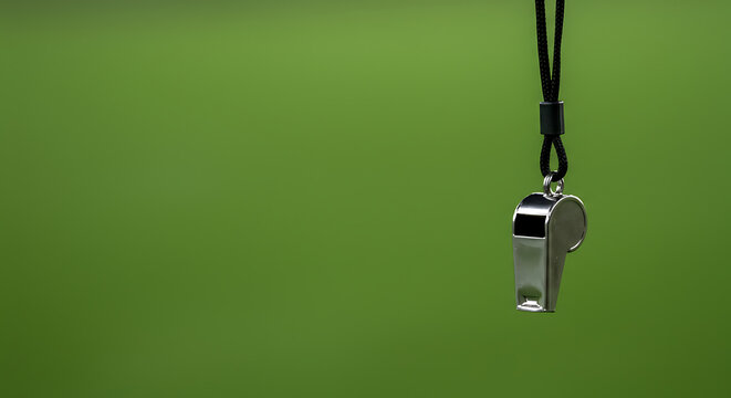 Silver Whistle on Lanyard Against Green Background: Minimalist Sports Referee Image