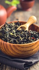 Dried tea leaves in a wooden bowl