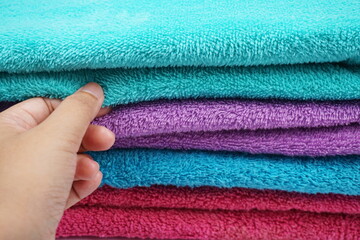 hand choosing stack of terry towel