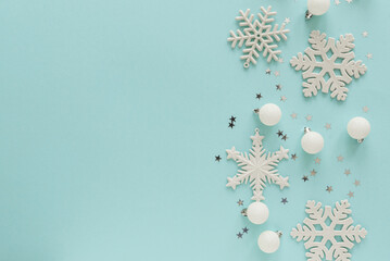 Fototapeta premium White Christmas Ornaments and Snowflakes on Light Blue Background