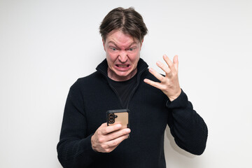 Angry Scandinavian mid adult man using phone against white background