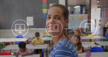 Smiling female teacher guiding students in elementary classroom, with floating digital icons