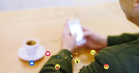 Man checking smartphone and glancing at coffee cup and floating reaction icons in cafe, copy space