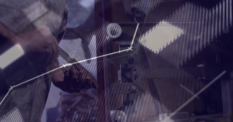 Shaping blank on lathe in workshop by craft worker holding chisel with graph overlays, copy space