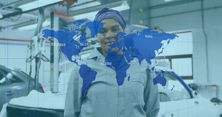 Standing mechanic wearing gray coverall in garage, silver car on car lift and world map overlay