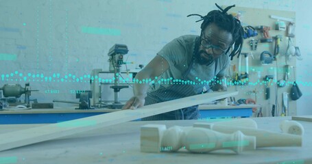 Inspecting apron-clad carpenter measuring plank at bench with drill press, pegboard, copy space