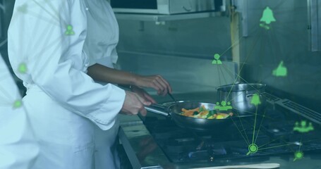 Cooking chefs wearing chef jackets stirring veggies in frying pan at gas range with network icons
