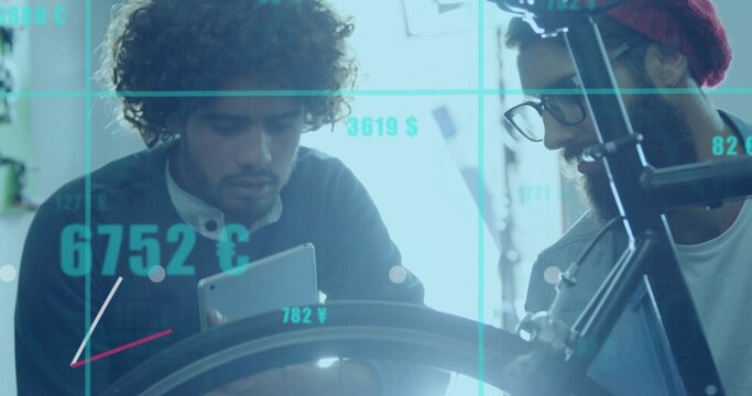 Examining two engineers reviewing tablet and bike wheel in workshop, with currency grid overlay - Powered by Adobe