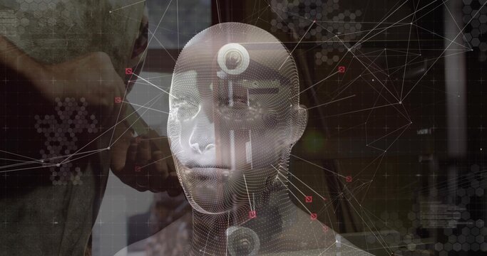 Male holding handheld scanner and pointing at holographic 3D head model in lab, with data nodes