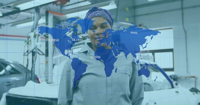 Standing mechanic wearing gray coverall in garage, silver car on car lift and world map overlay